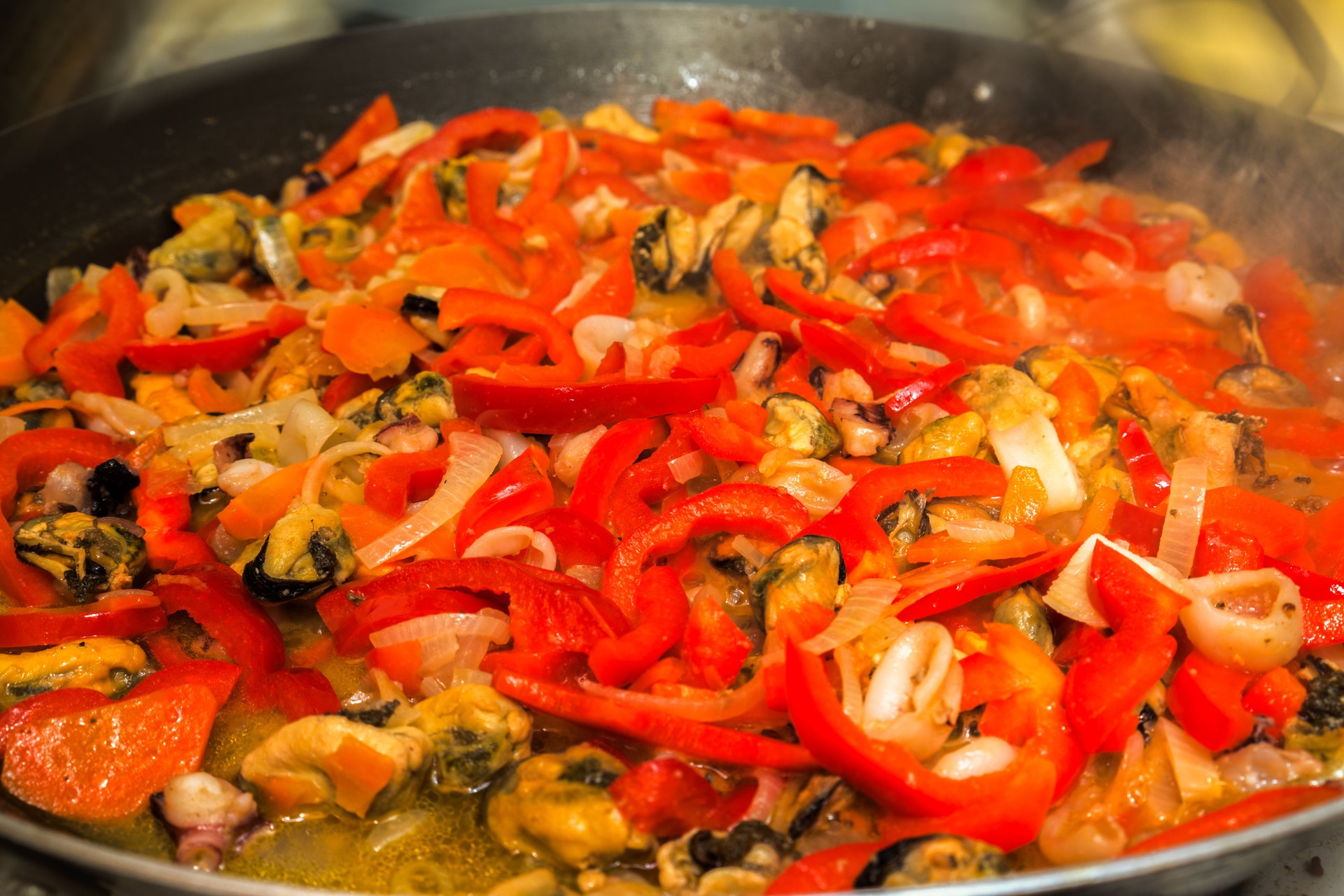 seafood paella cooking in the fry pan